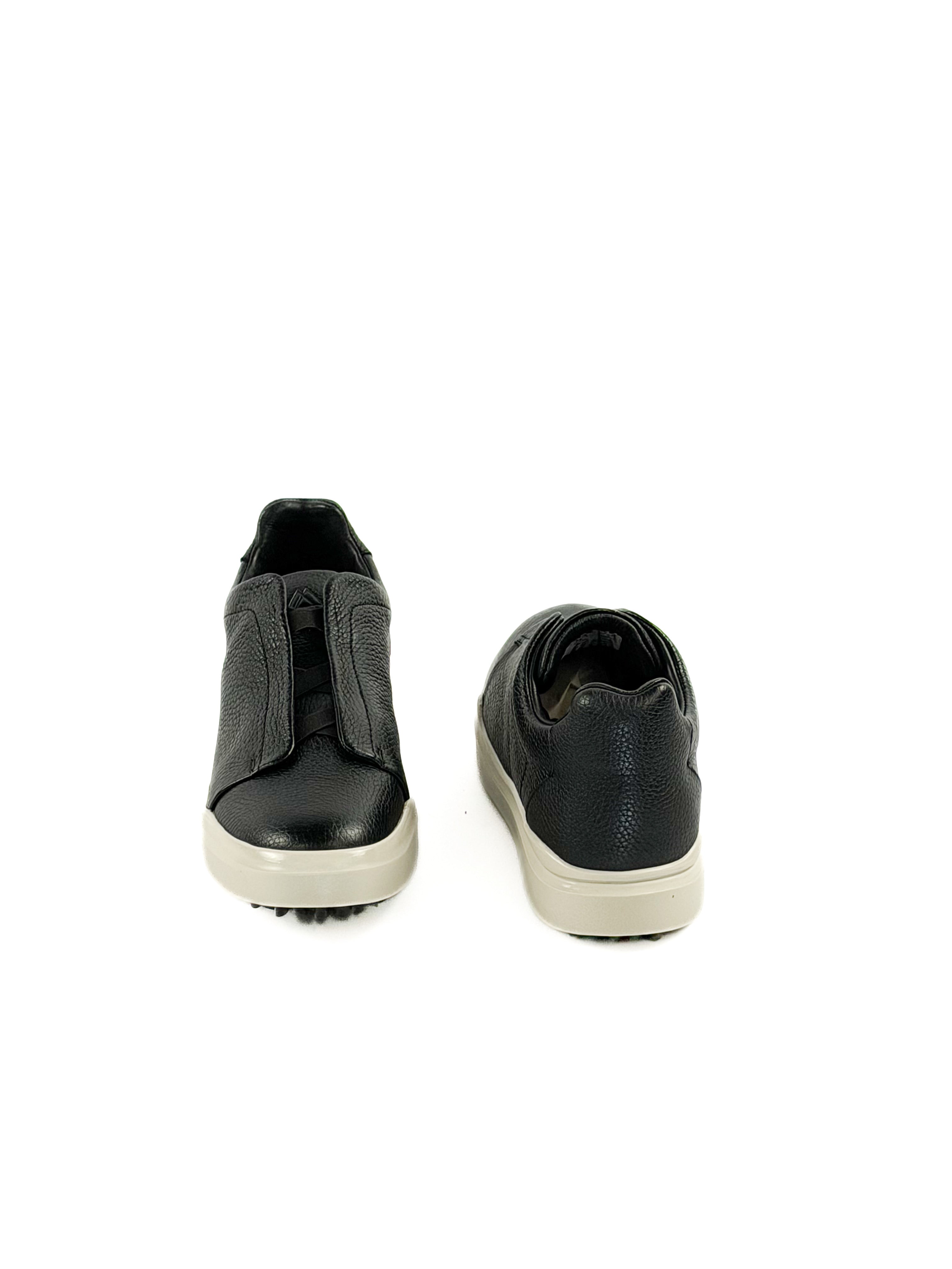 Pair of slip on black deer sneakers with durable traction