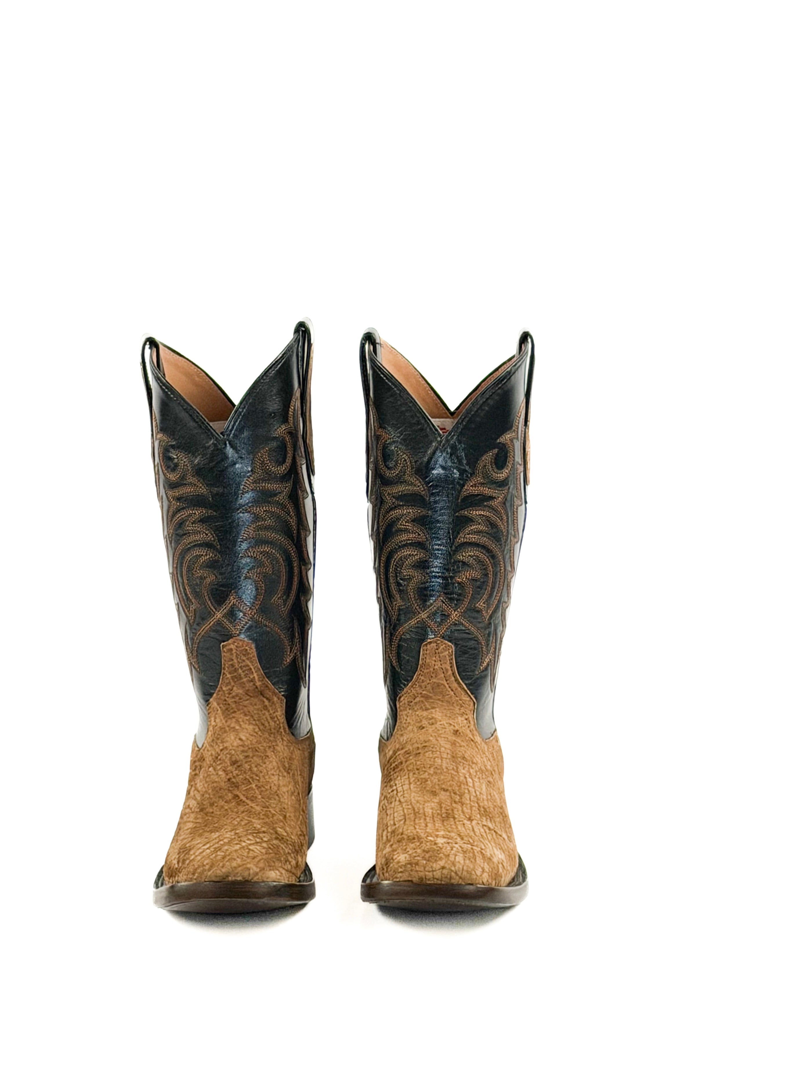 Pair of light brown cowboy boots with black leather upper shafts
