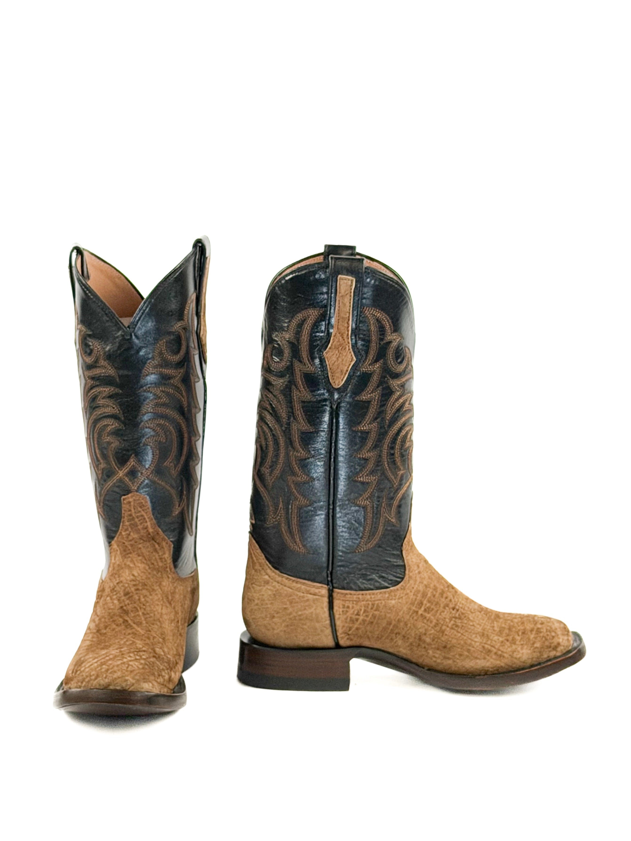 Pair of light brown cowboy boots with black leather upper shafts