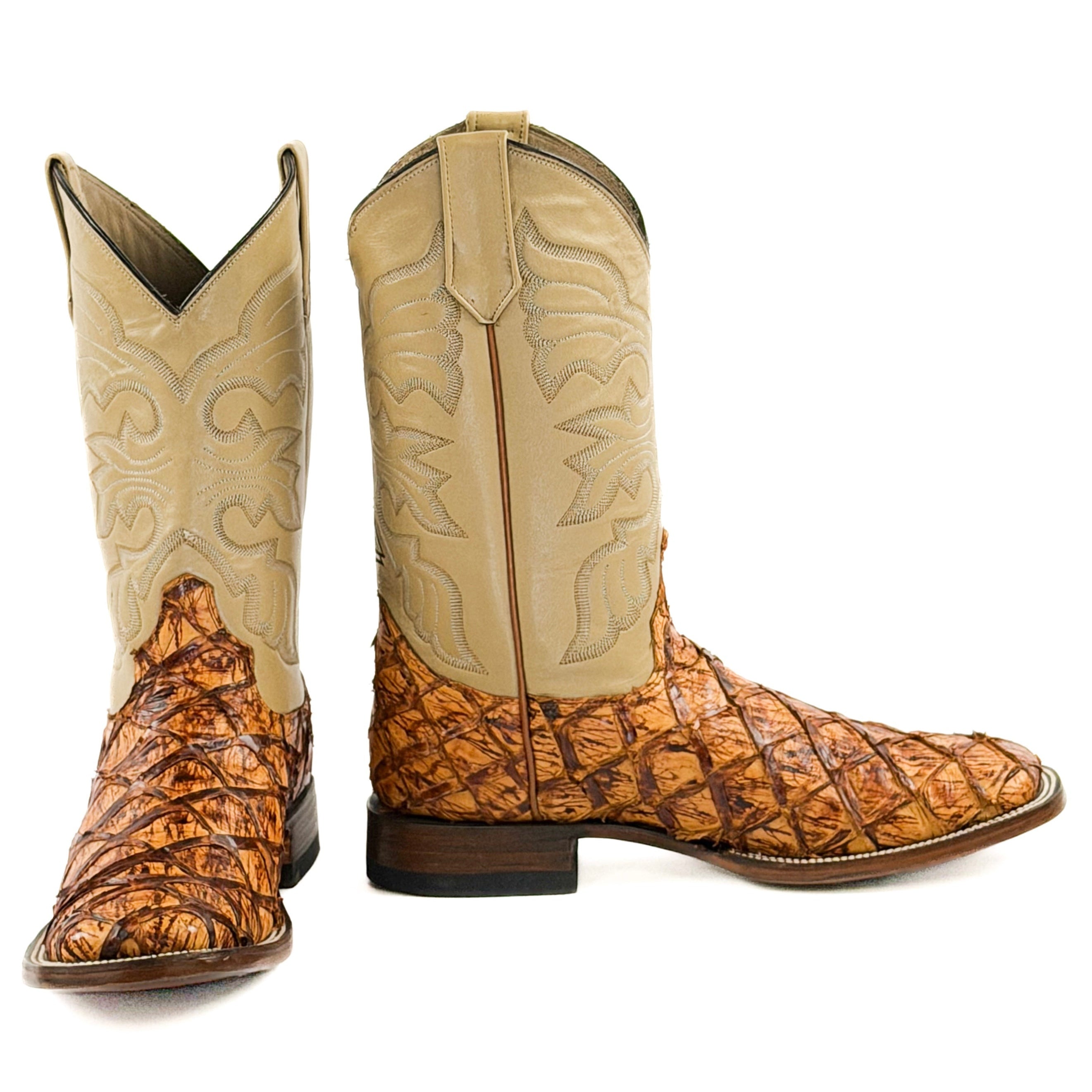 Pair of orange and brown cowboy boots with stitching design on the upper shafts
