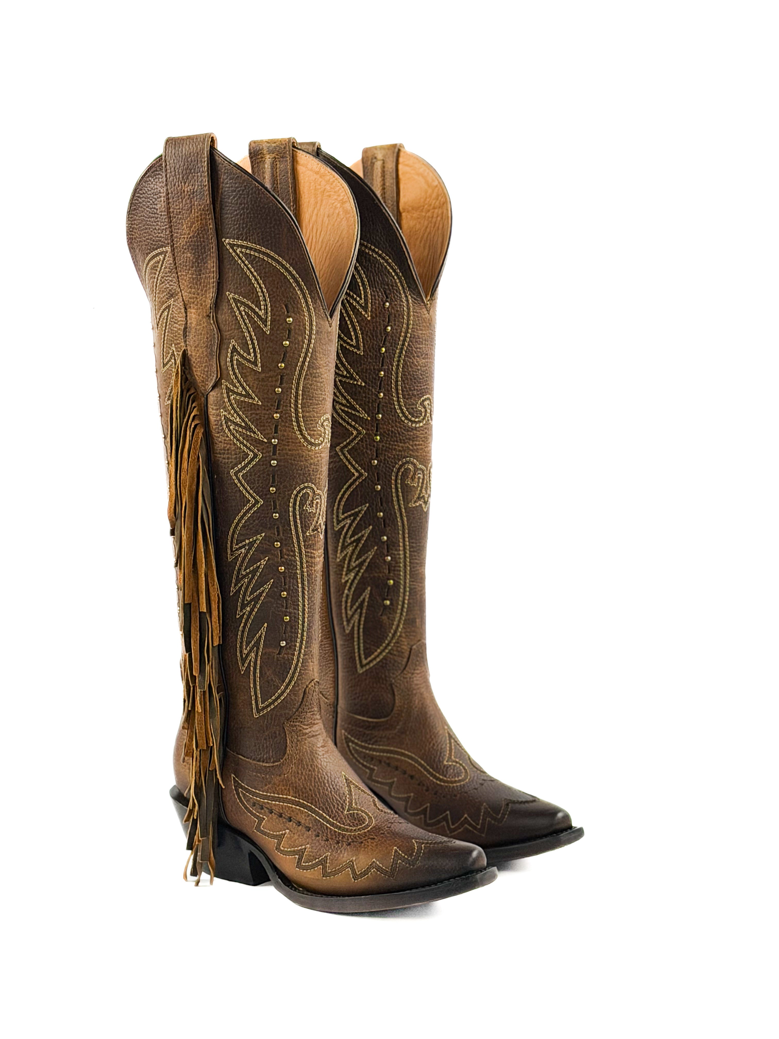 Pair of honey snip toe cowgirl boots with fringe and 2 inch heel
