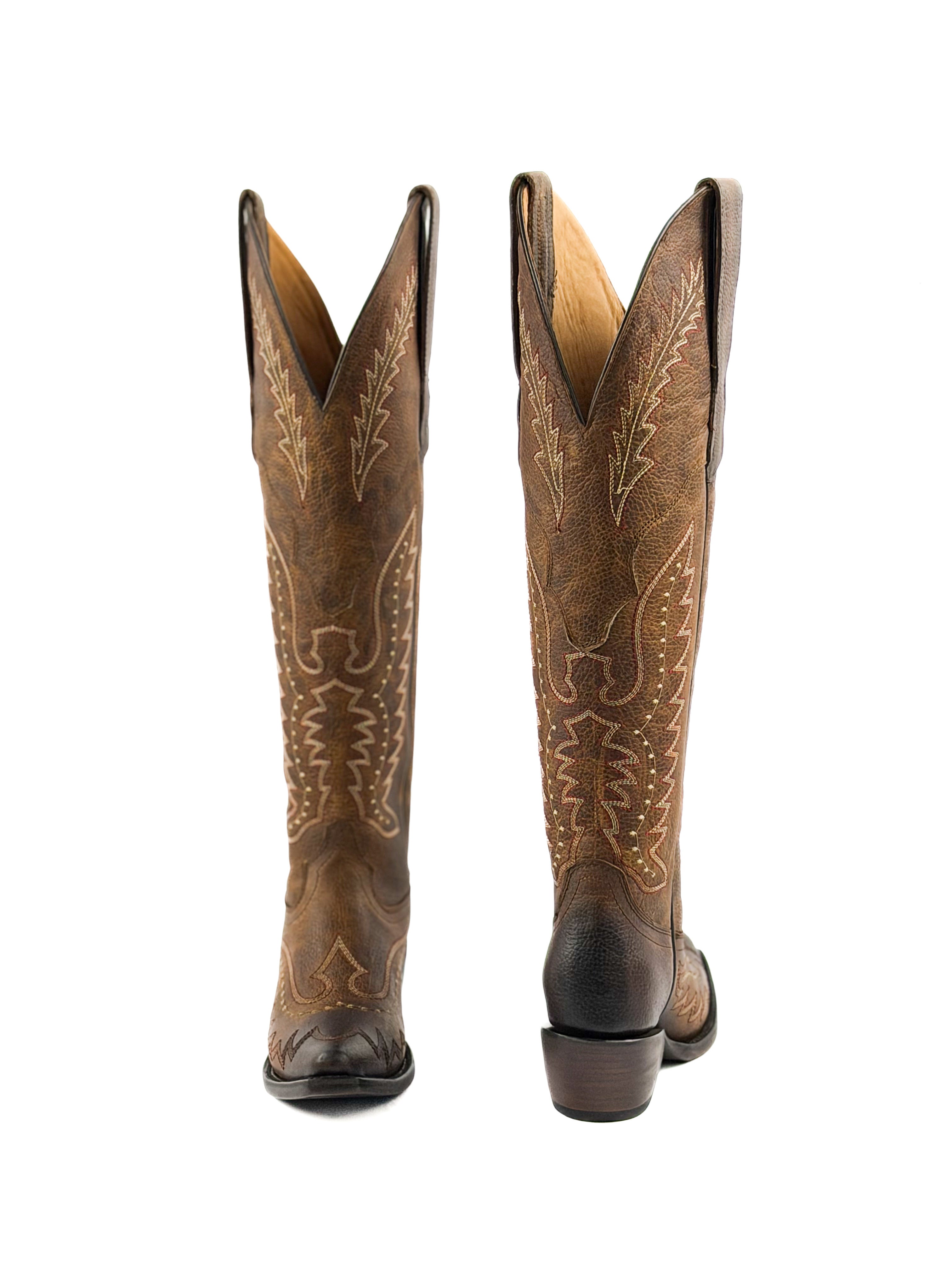 Pair of honey brown womens snip toe boots with intricate stitching