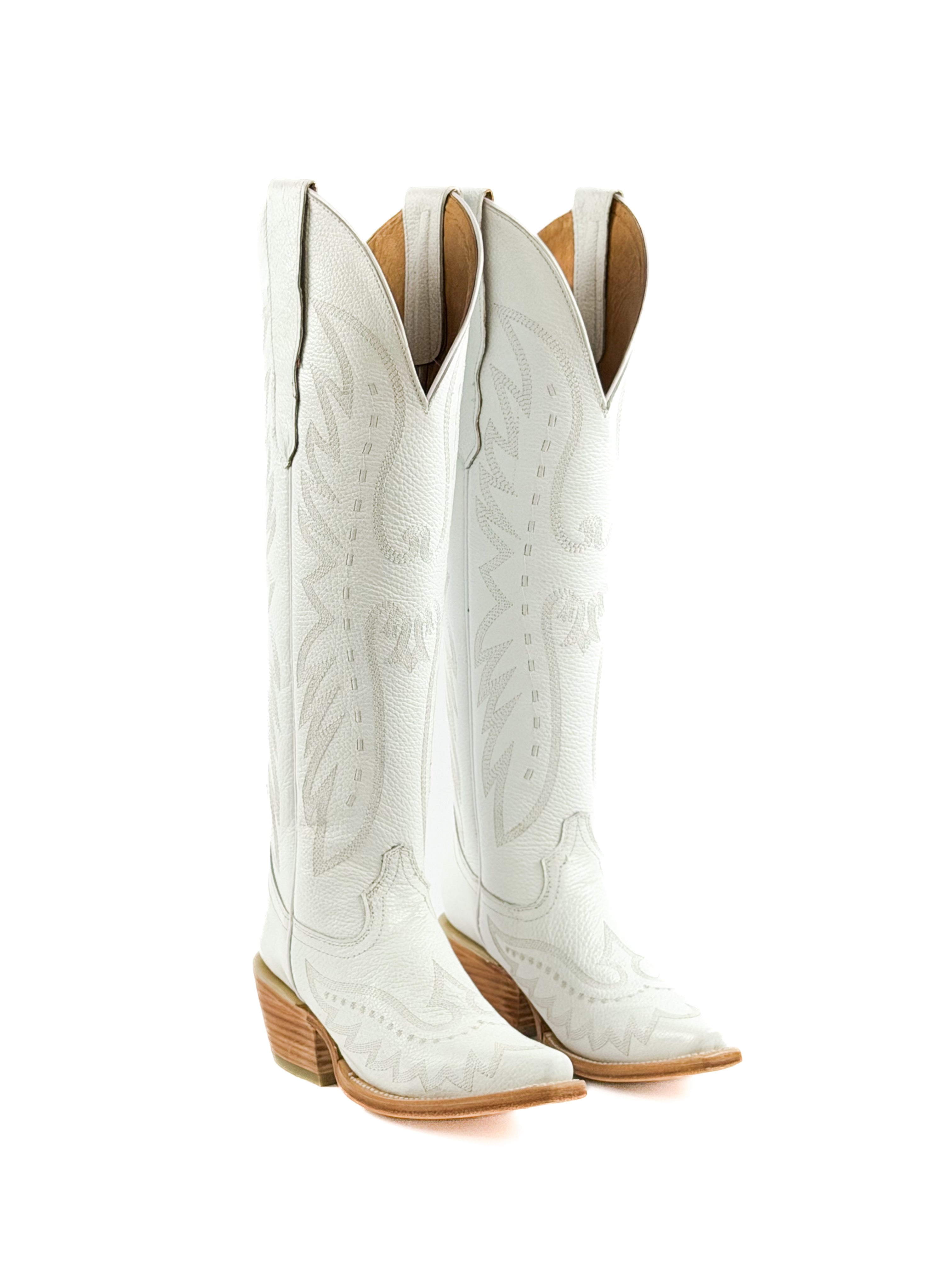 Pair of white cowgirl boots with brown leather soles and 2 inch heel