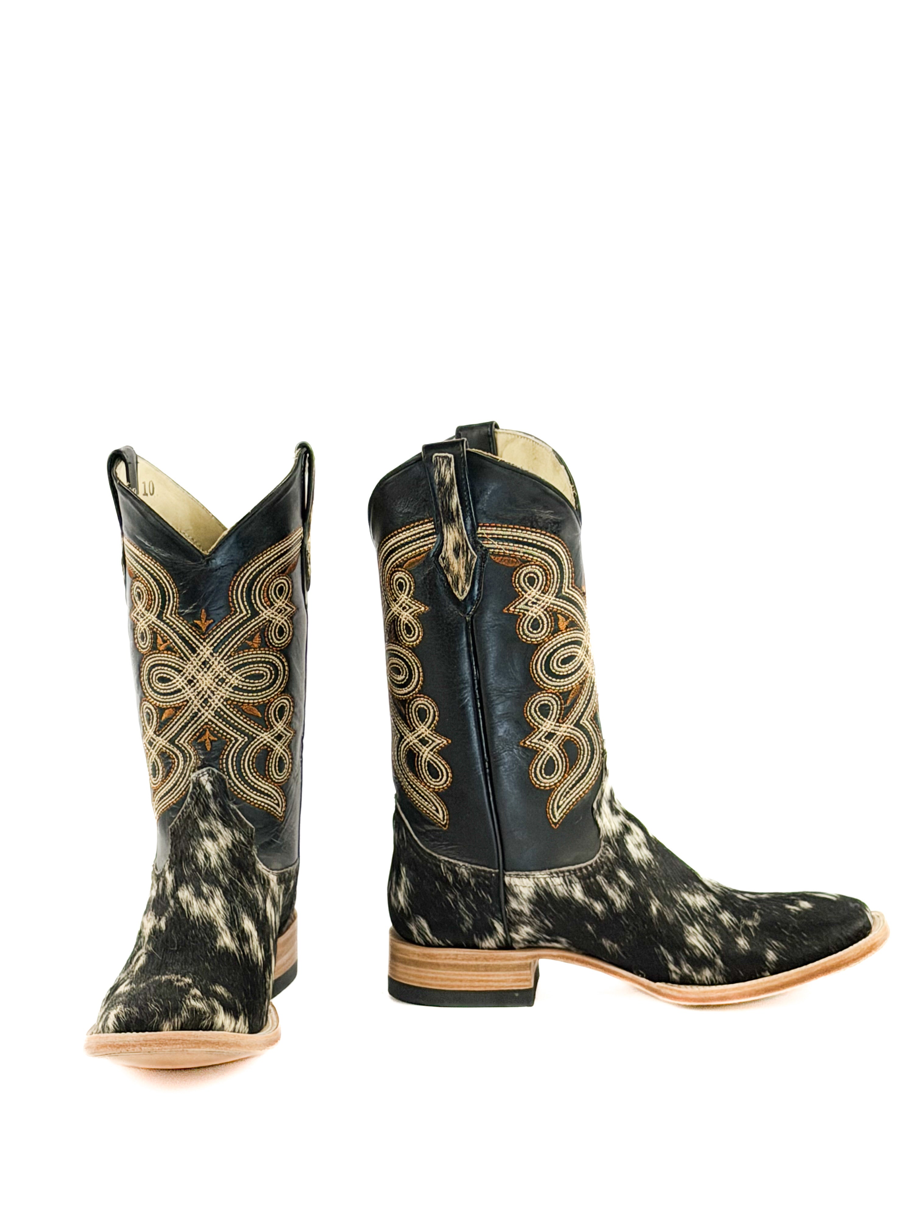 Pair of black and white cowhide square toe boots with intricate designs a black shaft