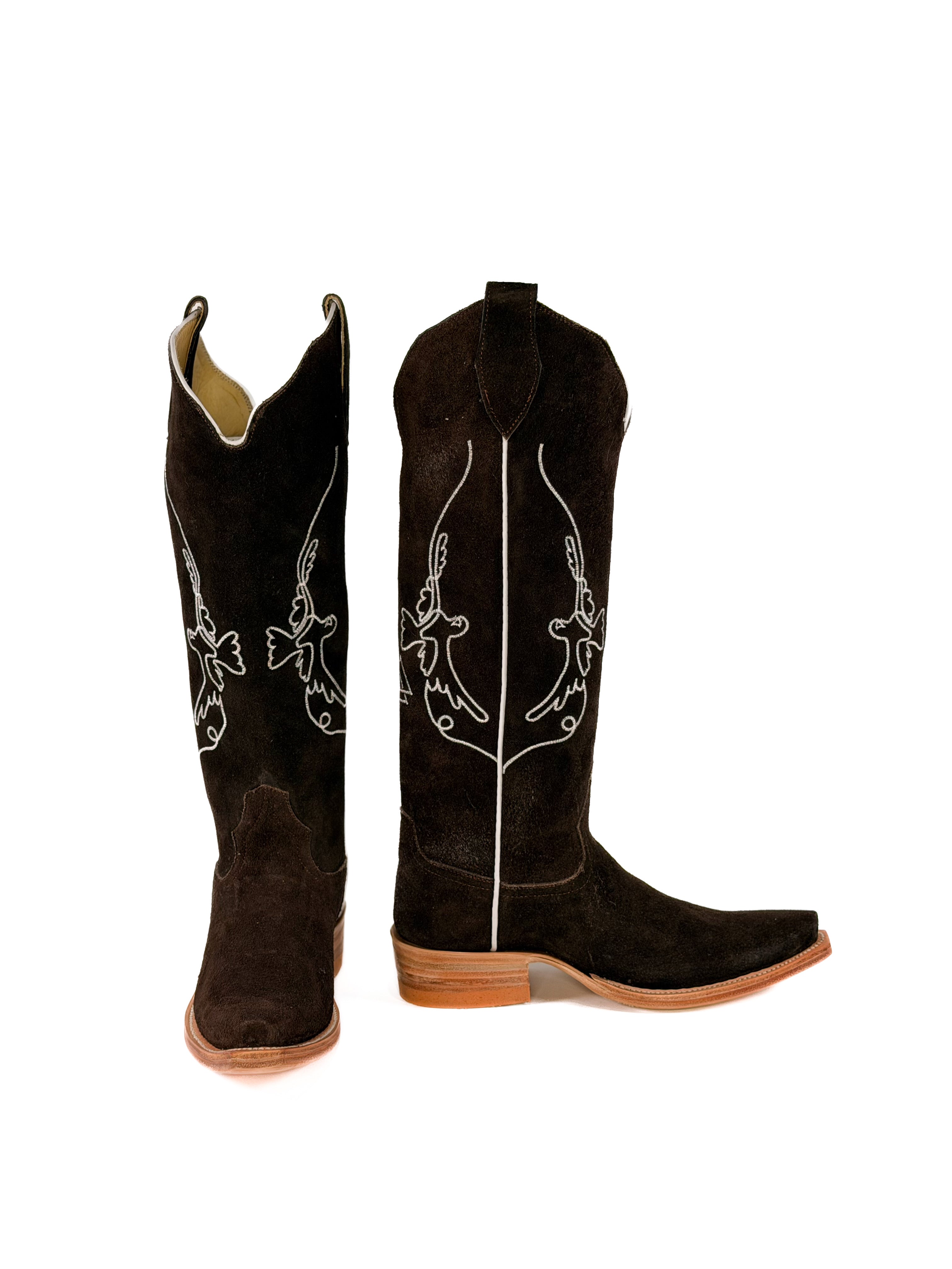 pair of brown suede cowgirl boots with white bird detailing