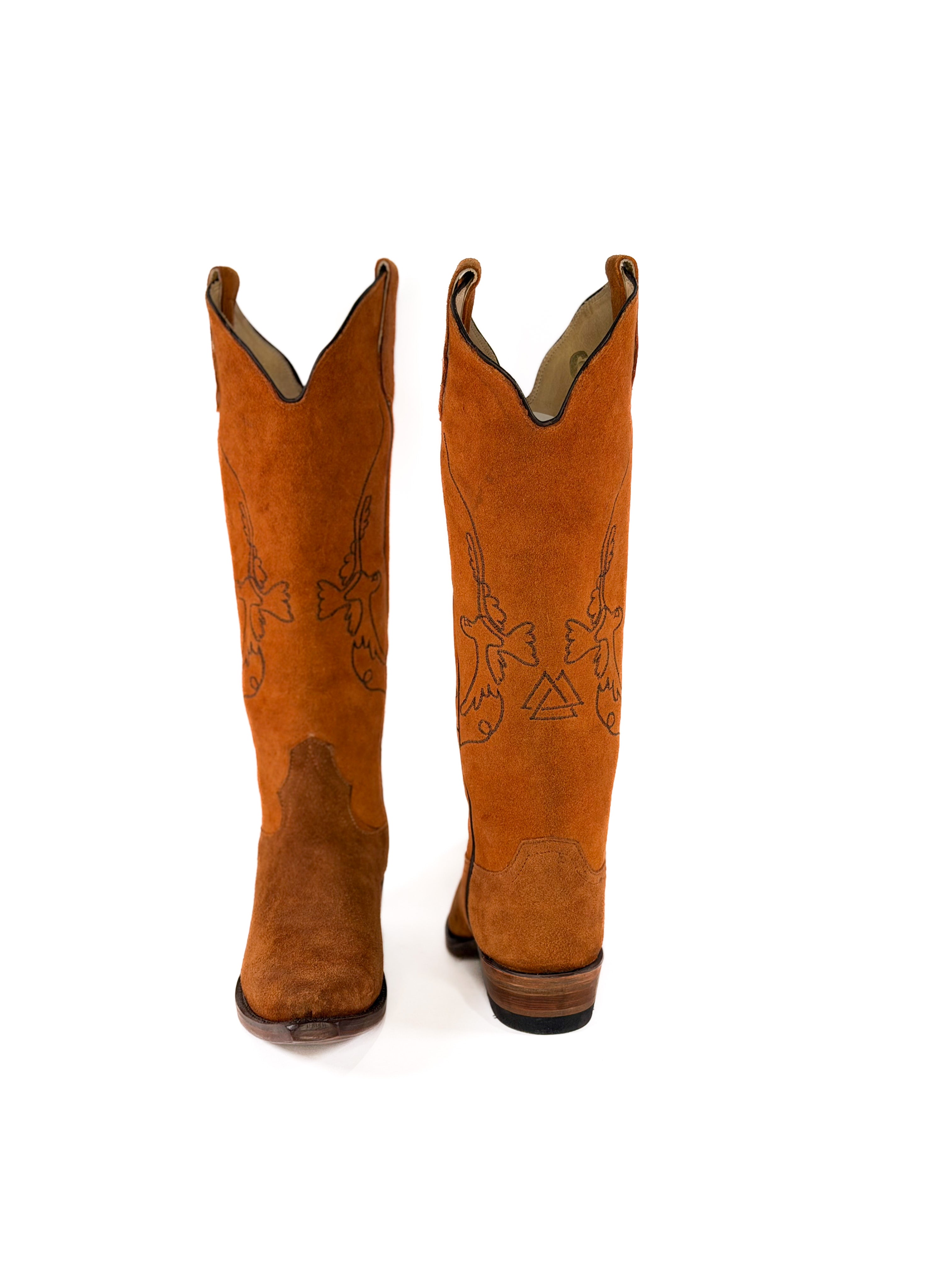 pair of burnt amber suede cowgirl boots with gold bird detailing