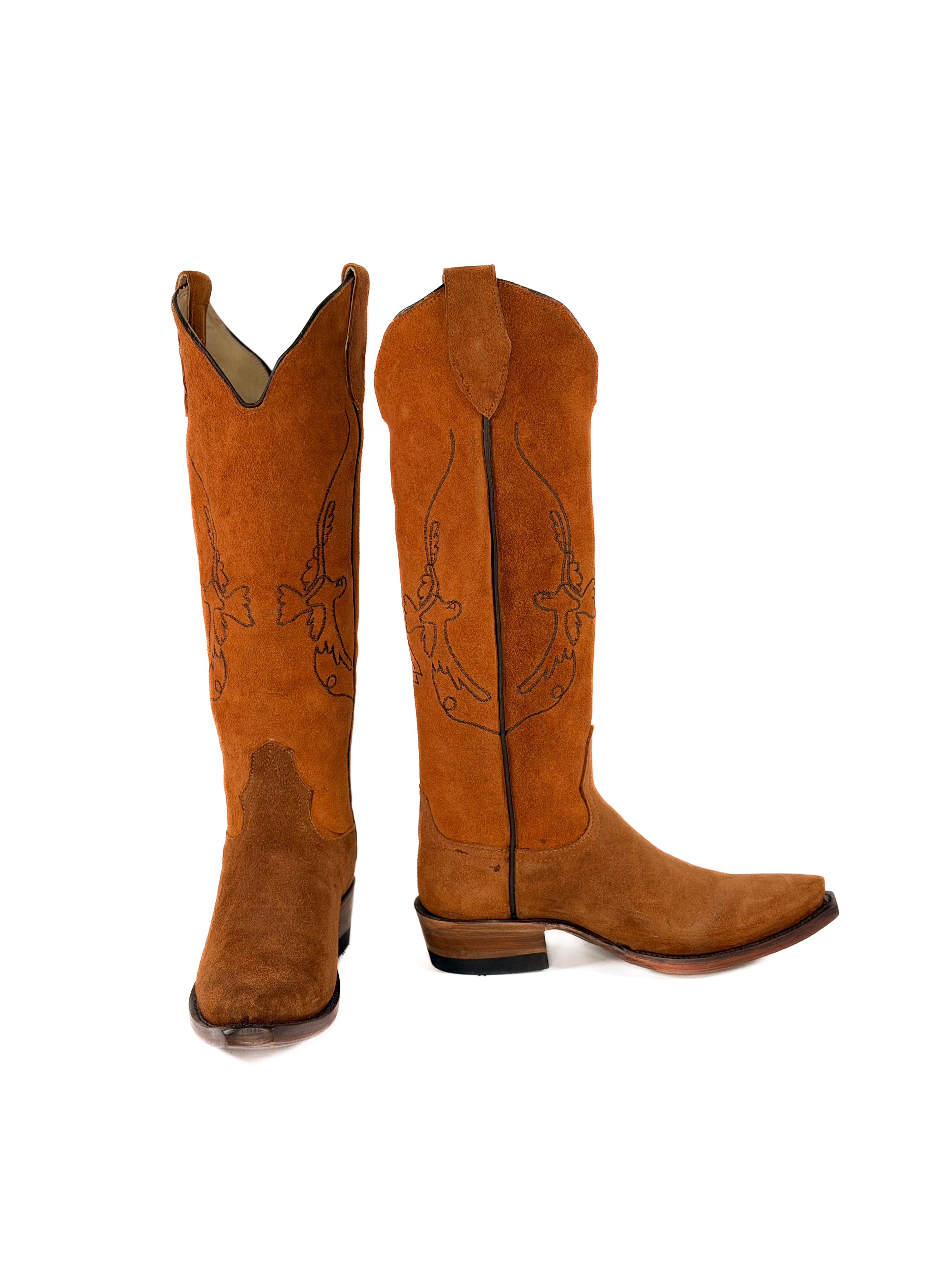 pair of burnt amber suede cowgirl boots with gold bird detailing