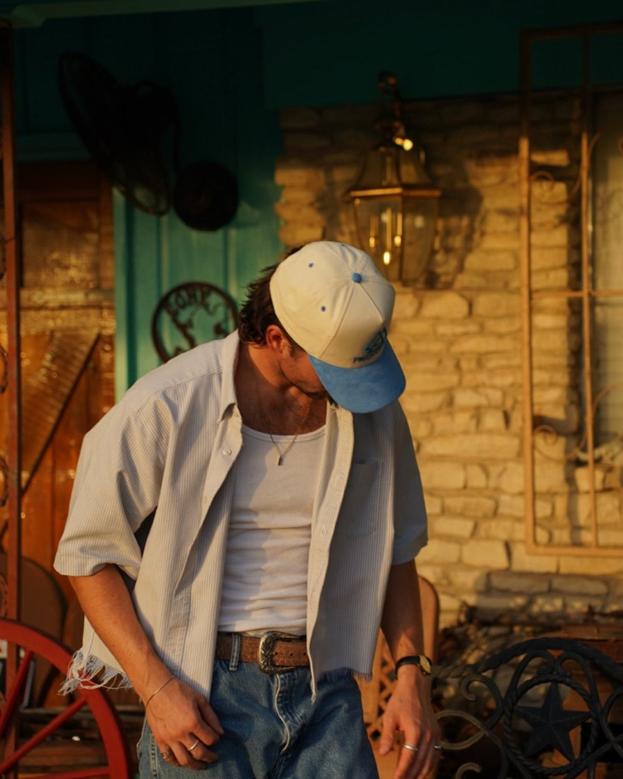 Trey on his porch in a Piedreros cap