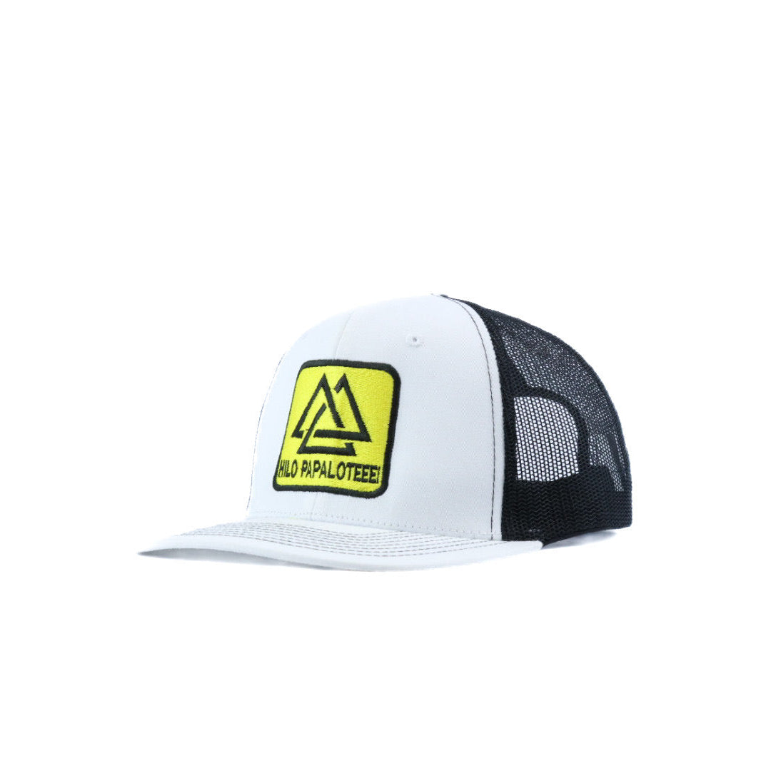 Black and yellow piedreros logo on a white and black trucker cap