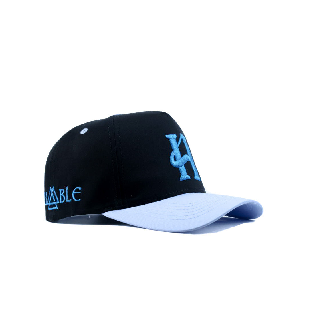 Black and white cap with blue branding on a white background