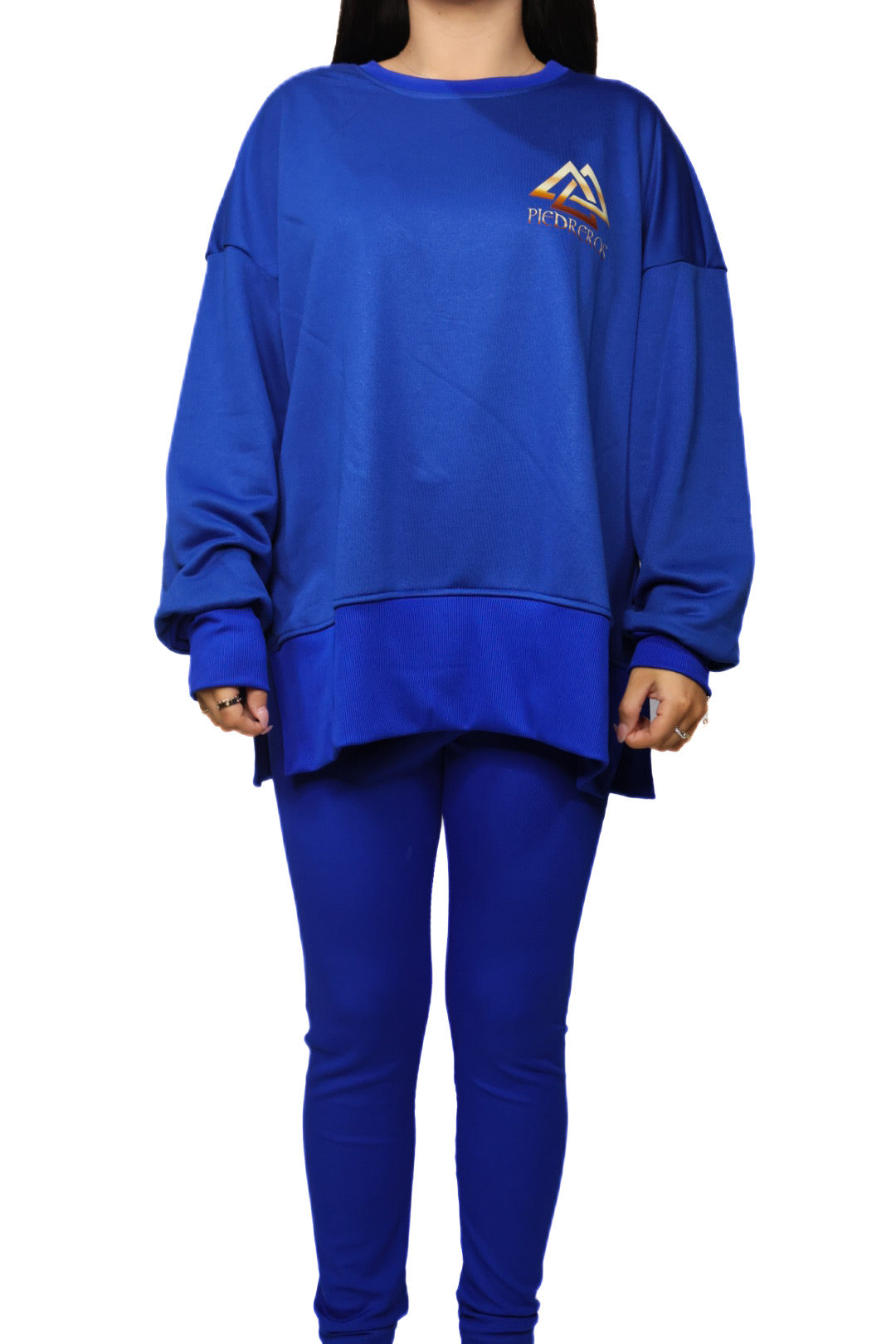 Person wearing a blue sweatshirt and pants set with piedreros logo