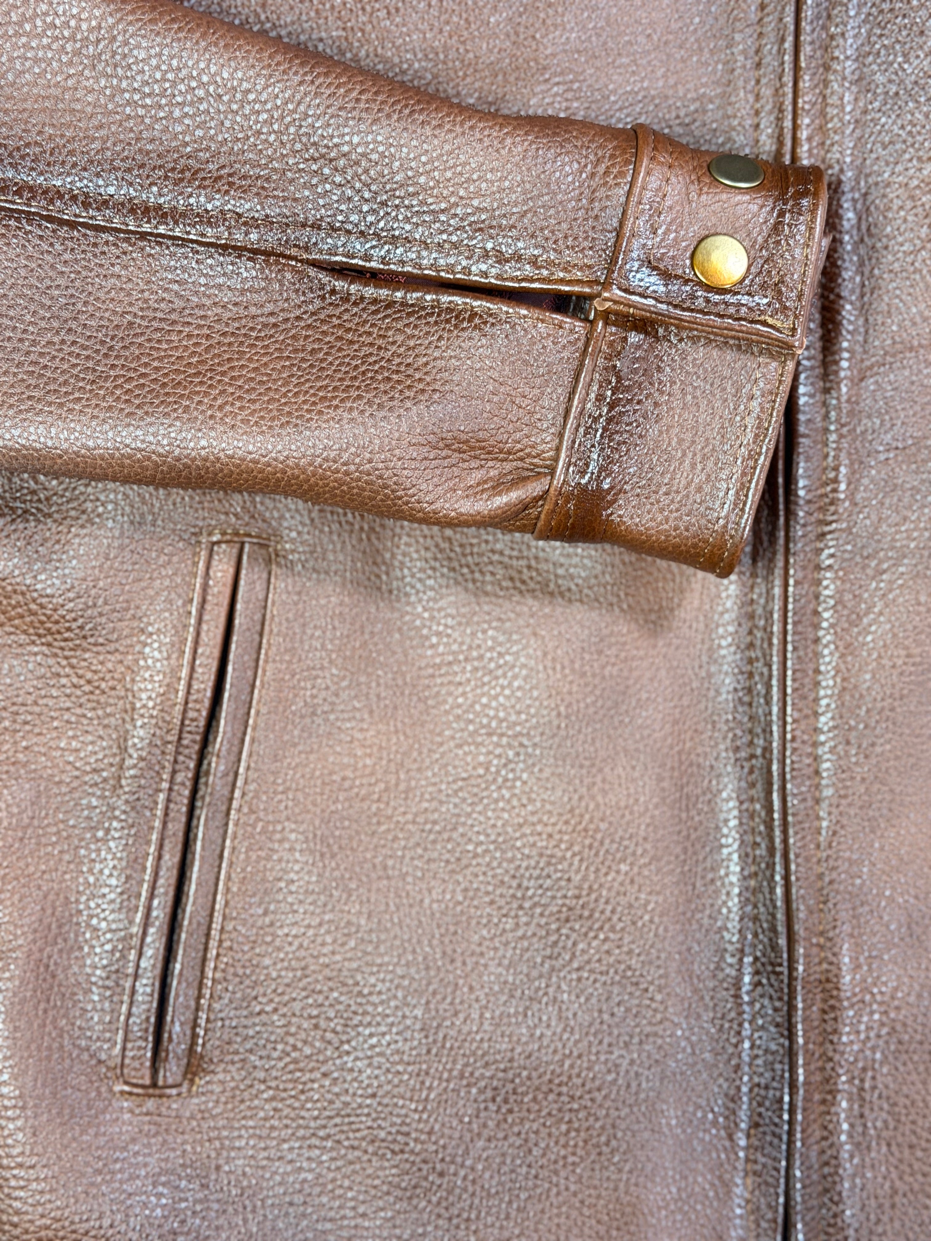 Close-up of a brown leather jacket with stitching detail