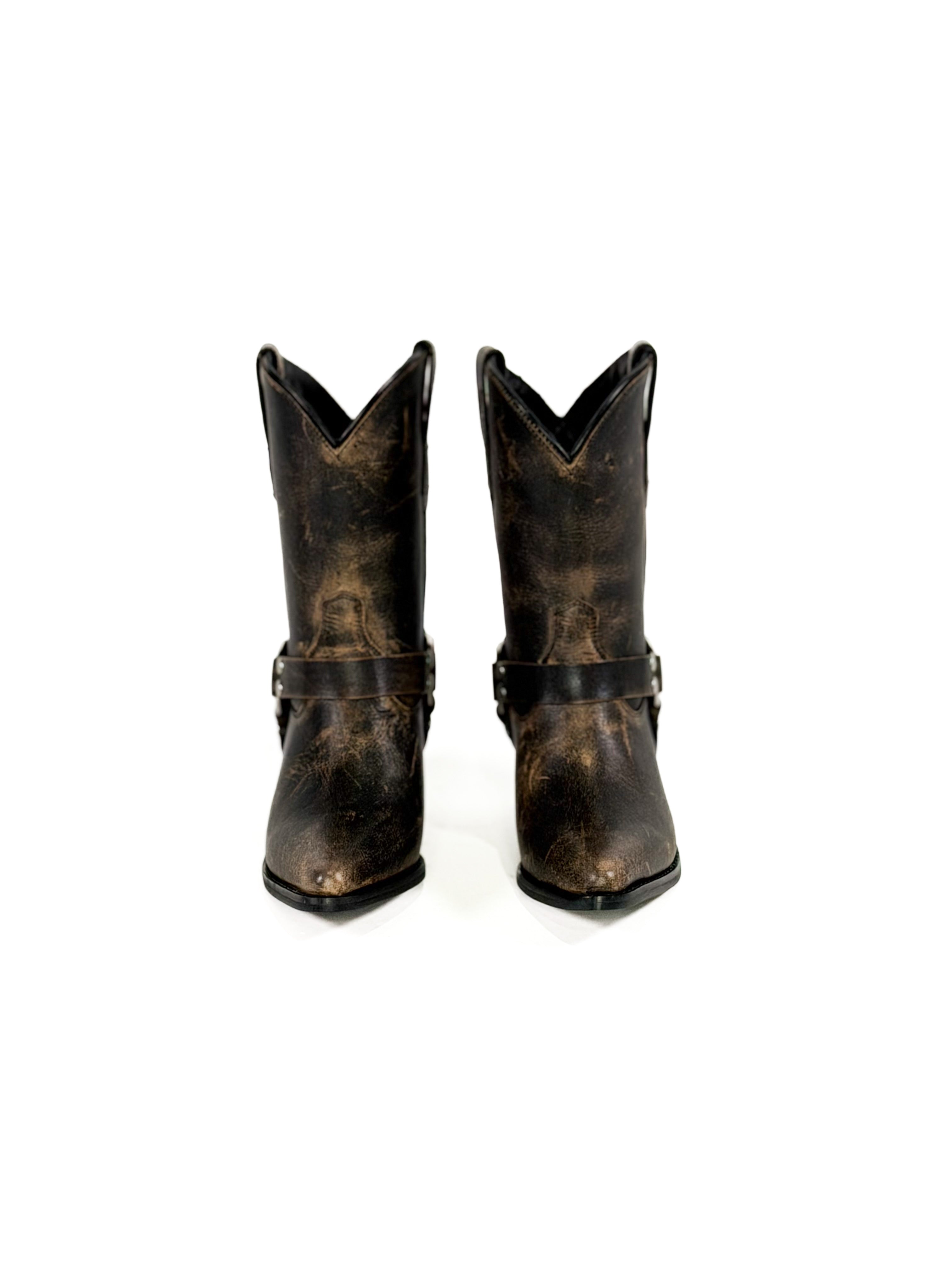 Black cowboy boots with buckles on a white background