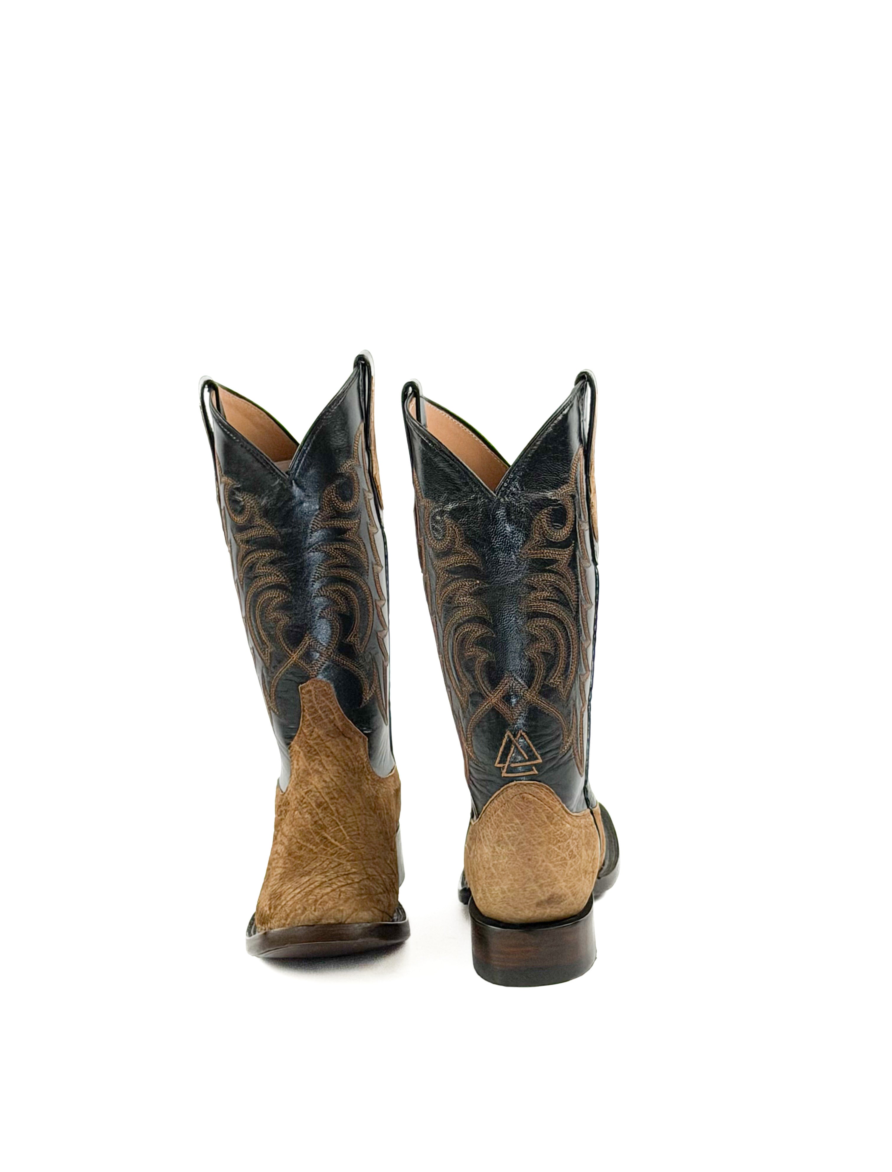 Pair of light brown cowboy boots with leather brown soles and black leather uppers 