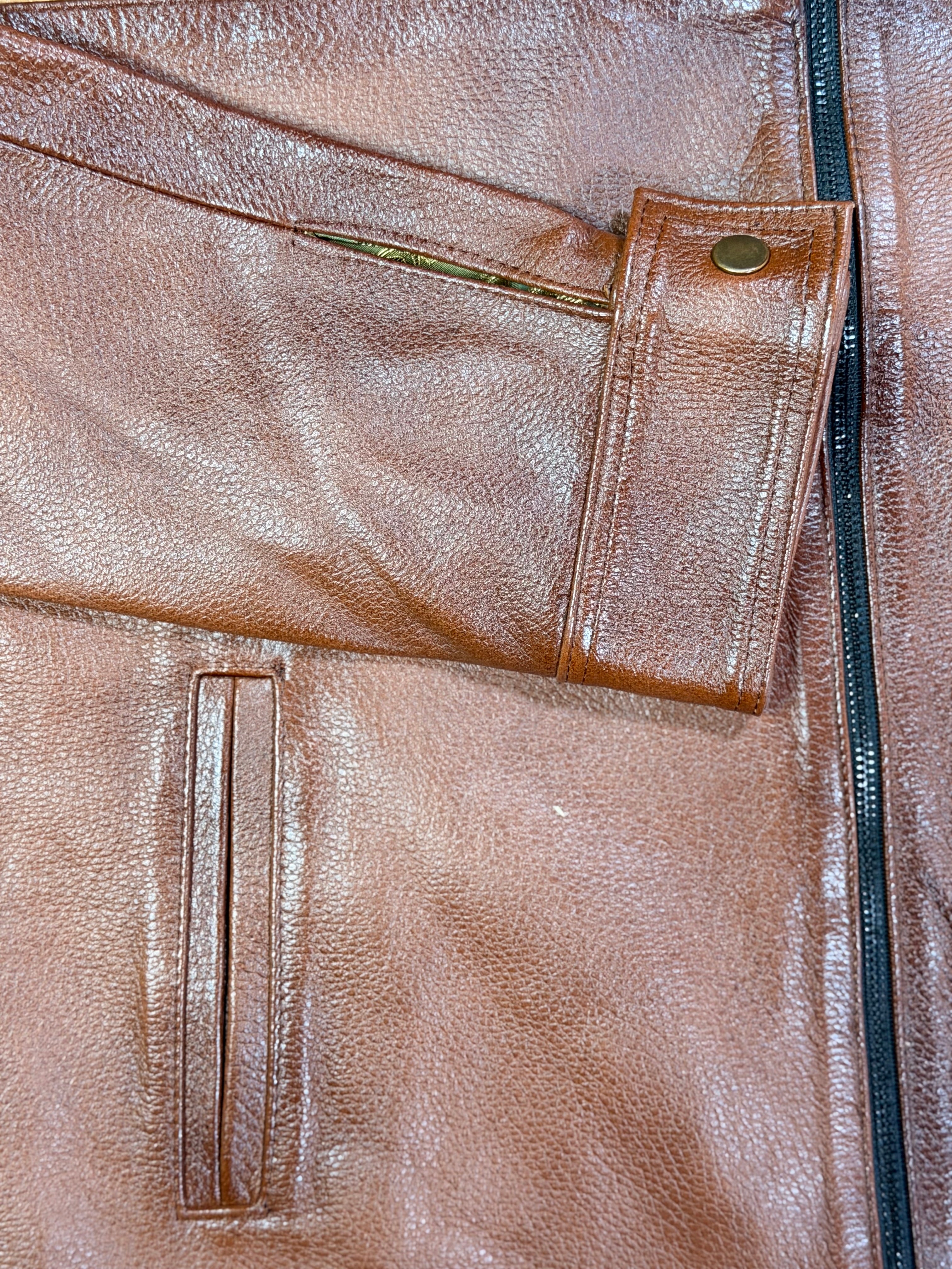 Close-up of a amber brown leather jacket with stitching details