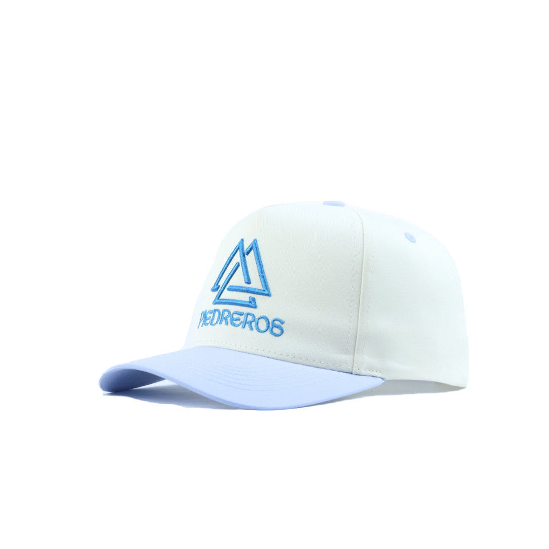 White cap with blue piedreros logo on a white background