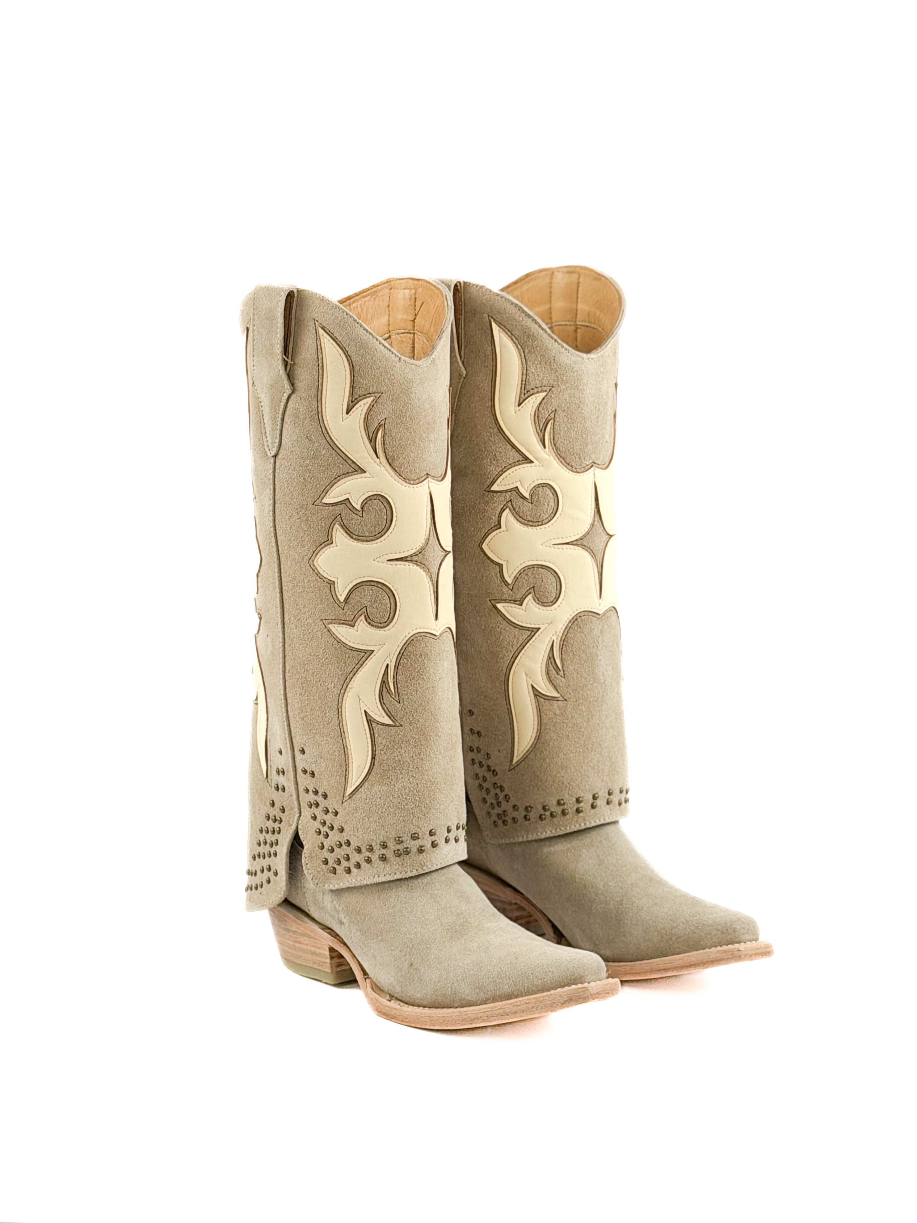 Pair of beige snip toe women’s boots with masquerade patterns and studded shaft
