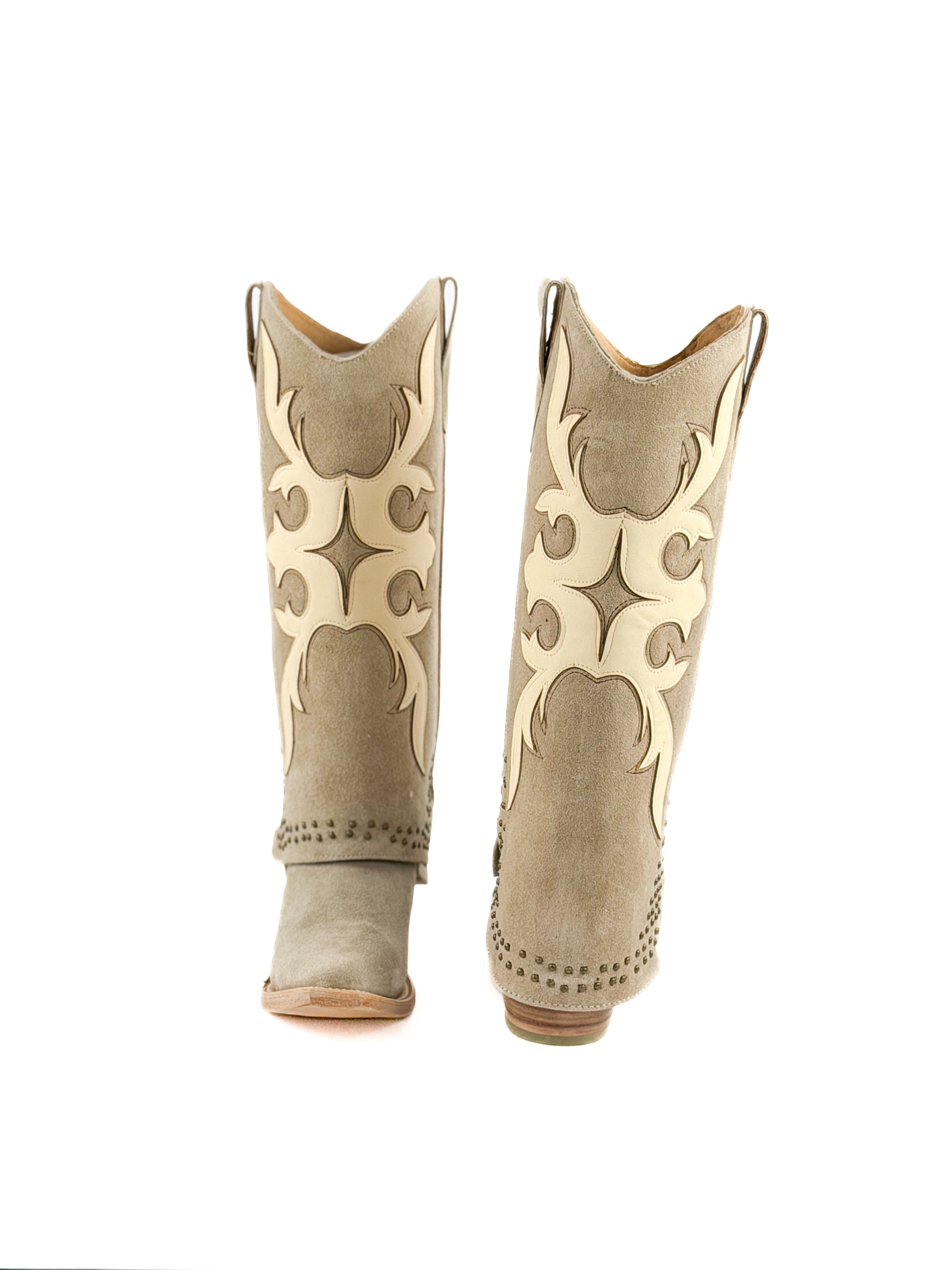 Pair of beige snip toe women’s boots with masquerade patterns and studded shaft
