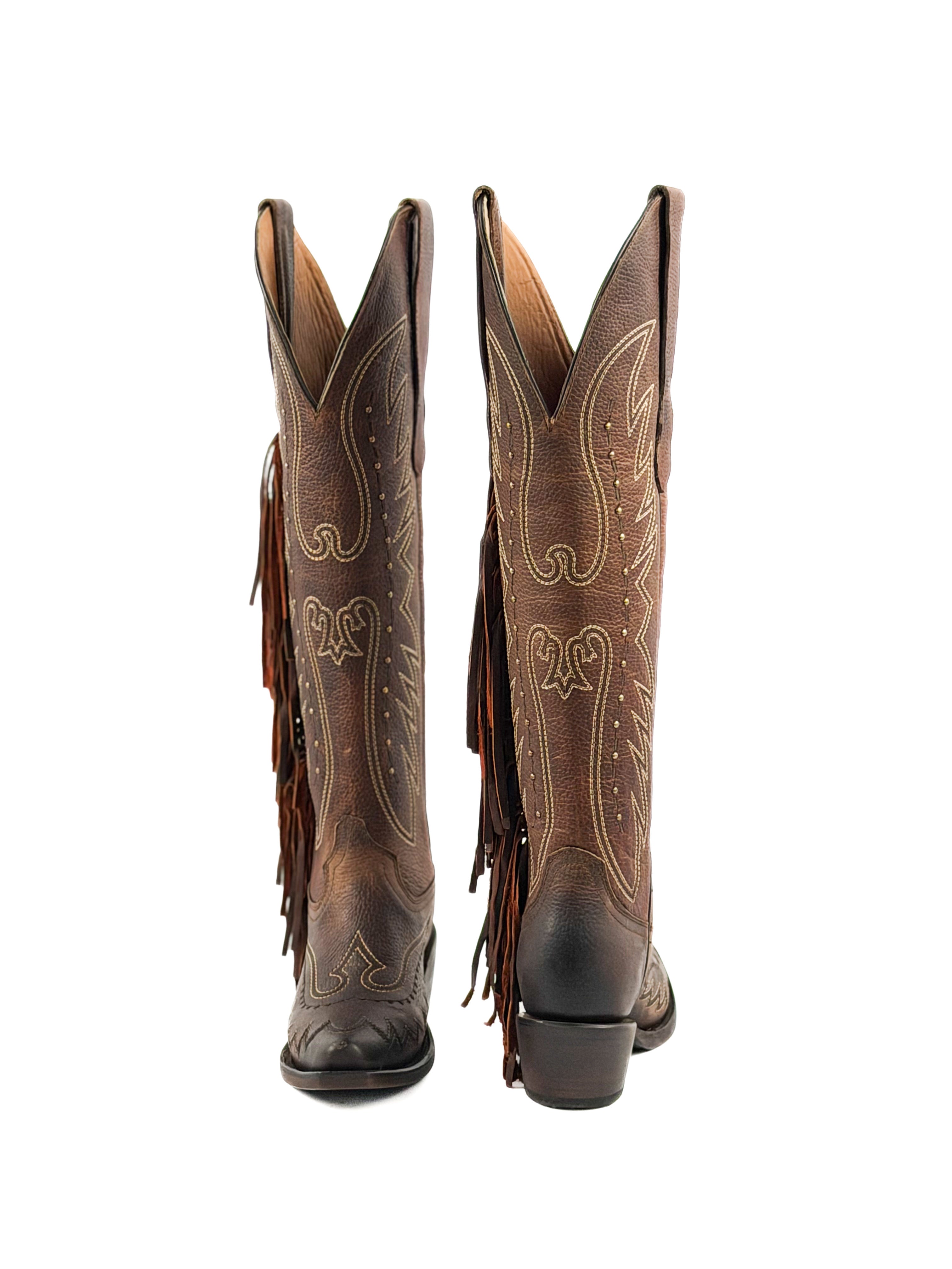 Pair of brown snip toe cowgirl boots with intricate designs, studs, fringes, and 2 inch heel.