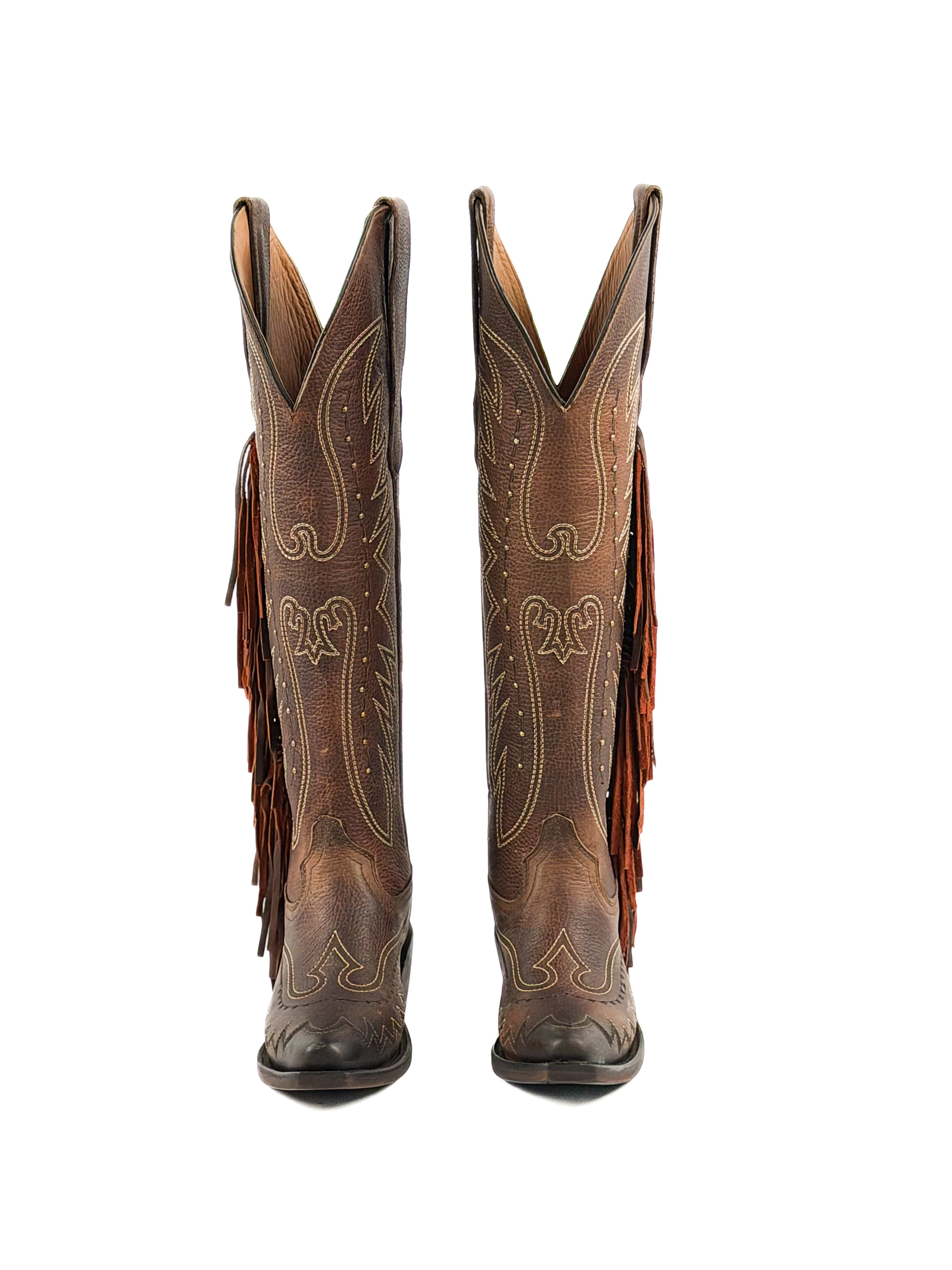 Pair of brown snip toe cowgirl boots with intricate designs, studs, fringes, and 2 inch heel.