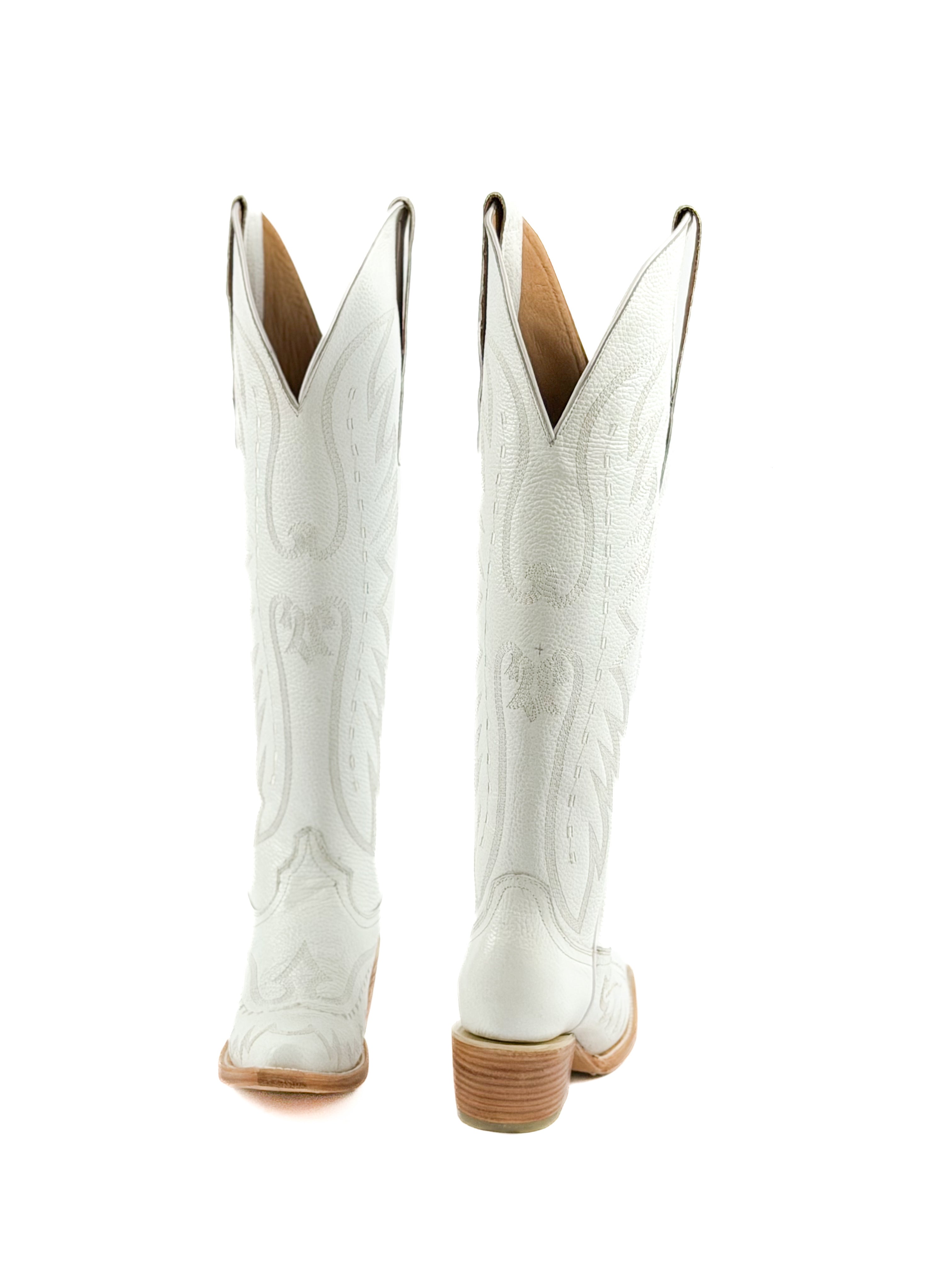 Pair of white cowgirl boots with brown leather soles and 2 inch heel