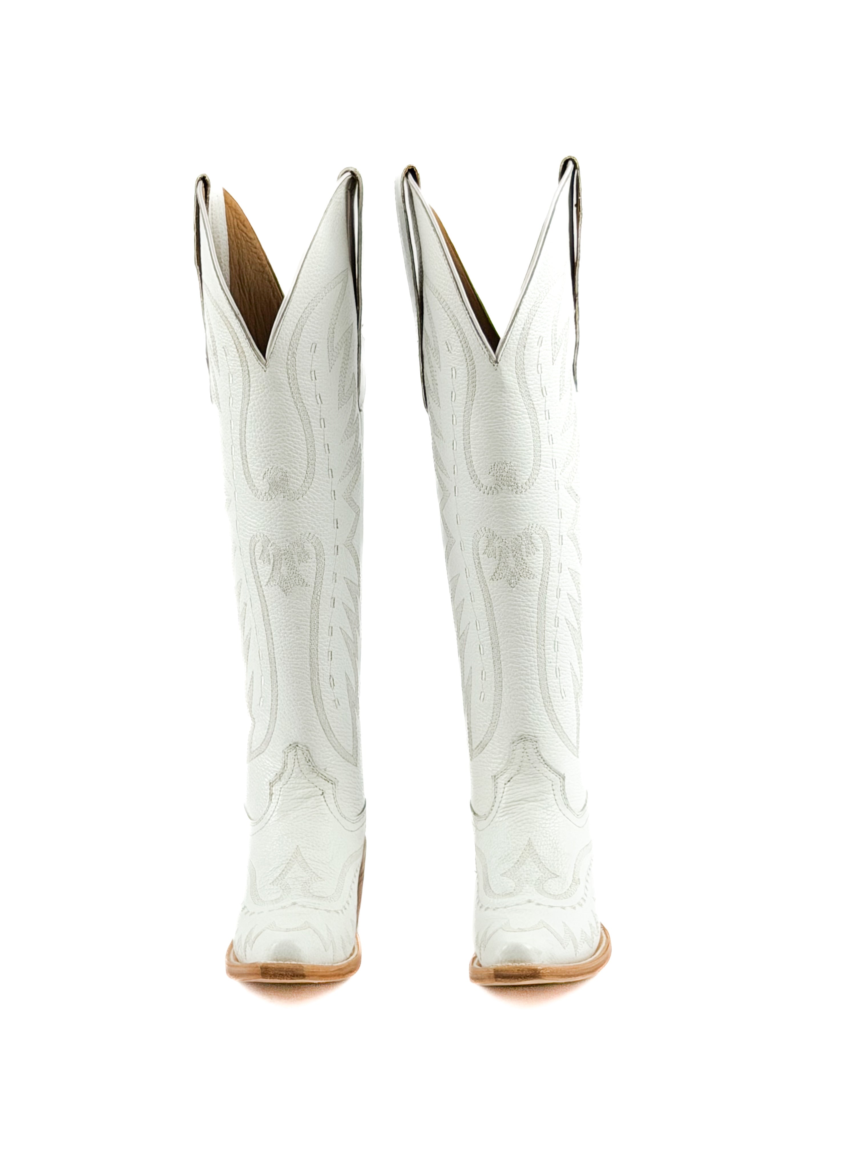 Pair of white cowgirl boots with brown leather soles and 2 inch heel