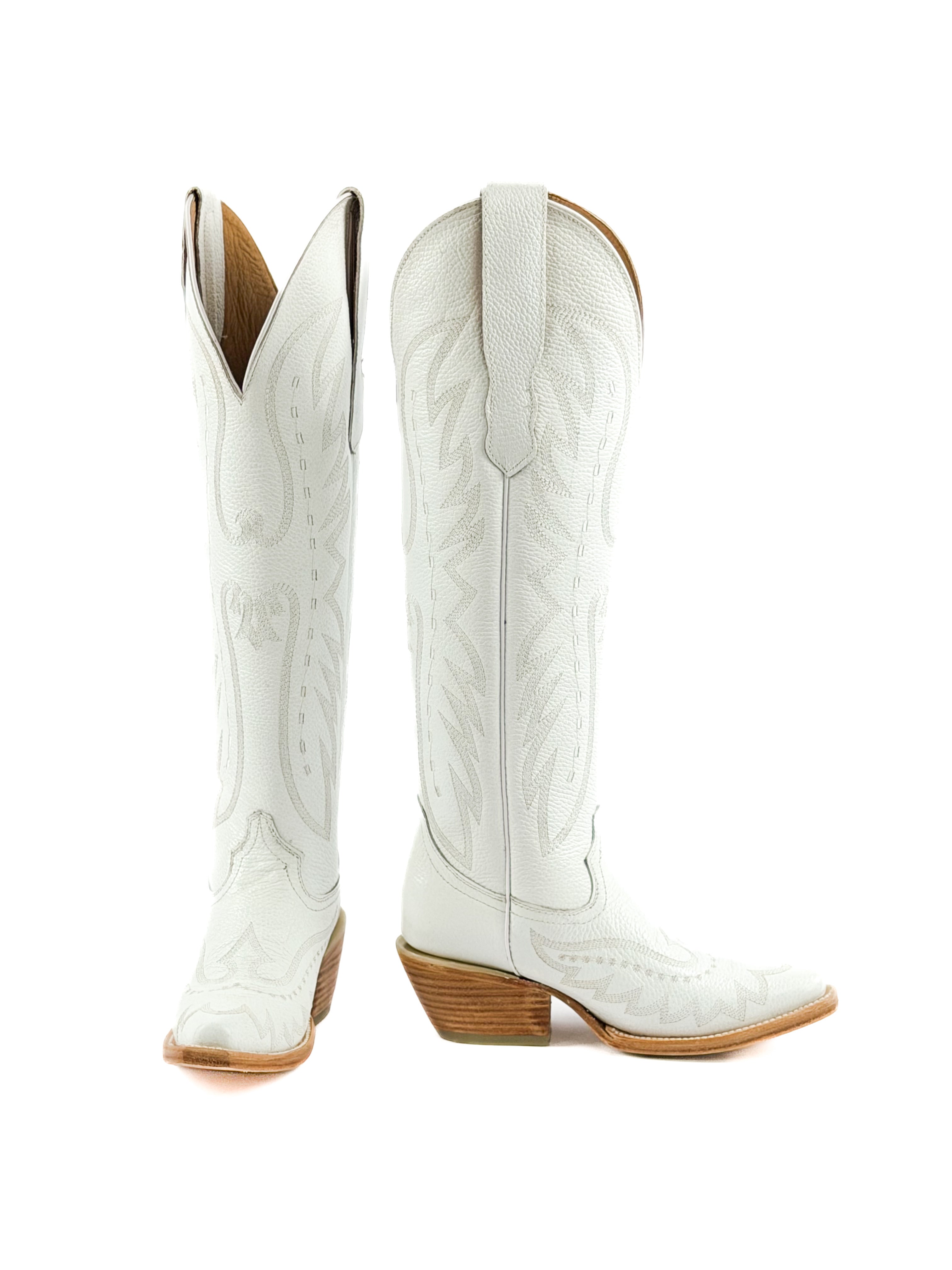 Pair of white cowgirl boots with brown leather soles and 2 inch heel