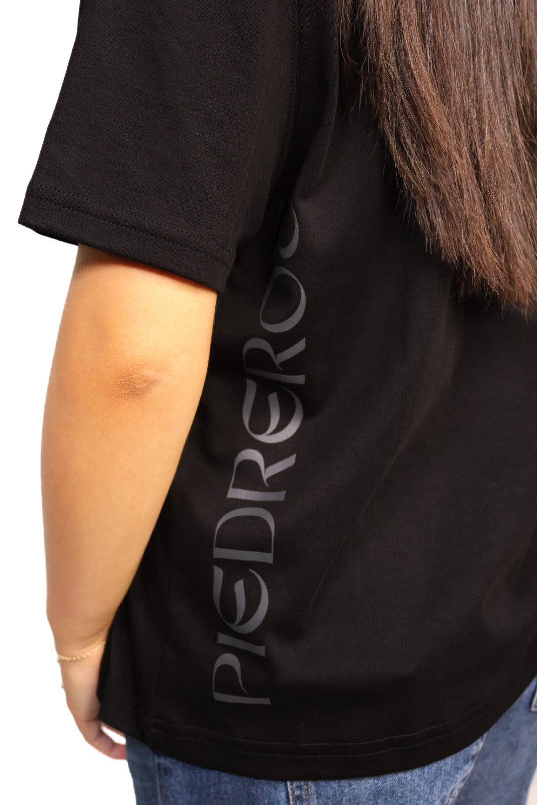 women's black shirt with piedreros logo on the side