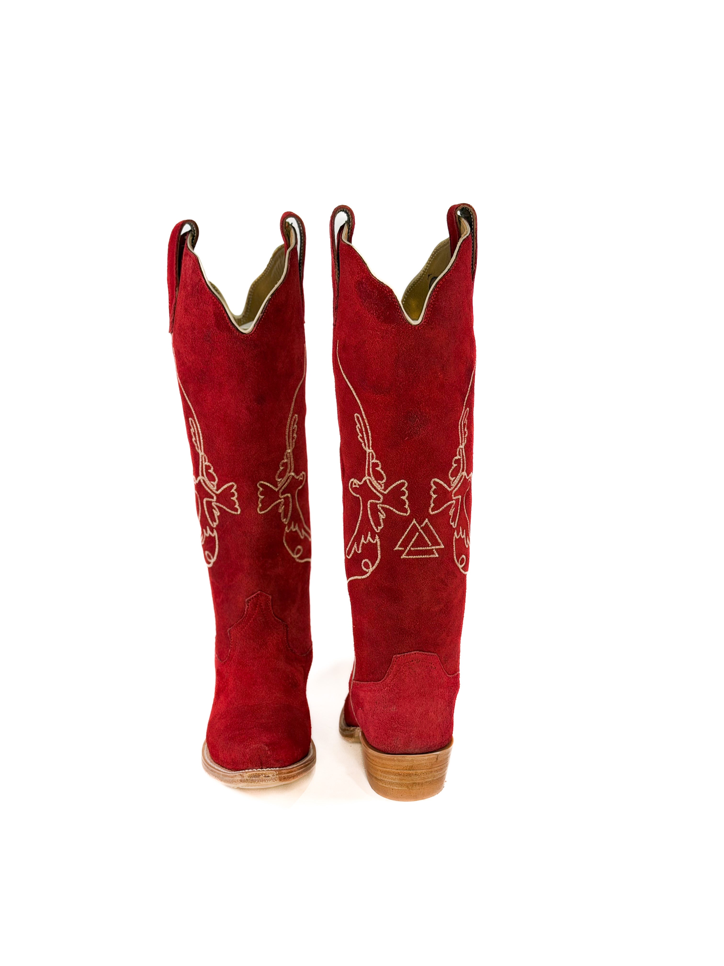 pair of red suede cowgirl boots with gold bird detailing