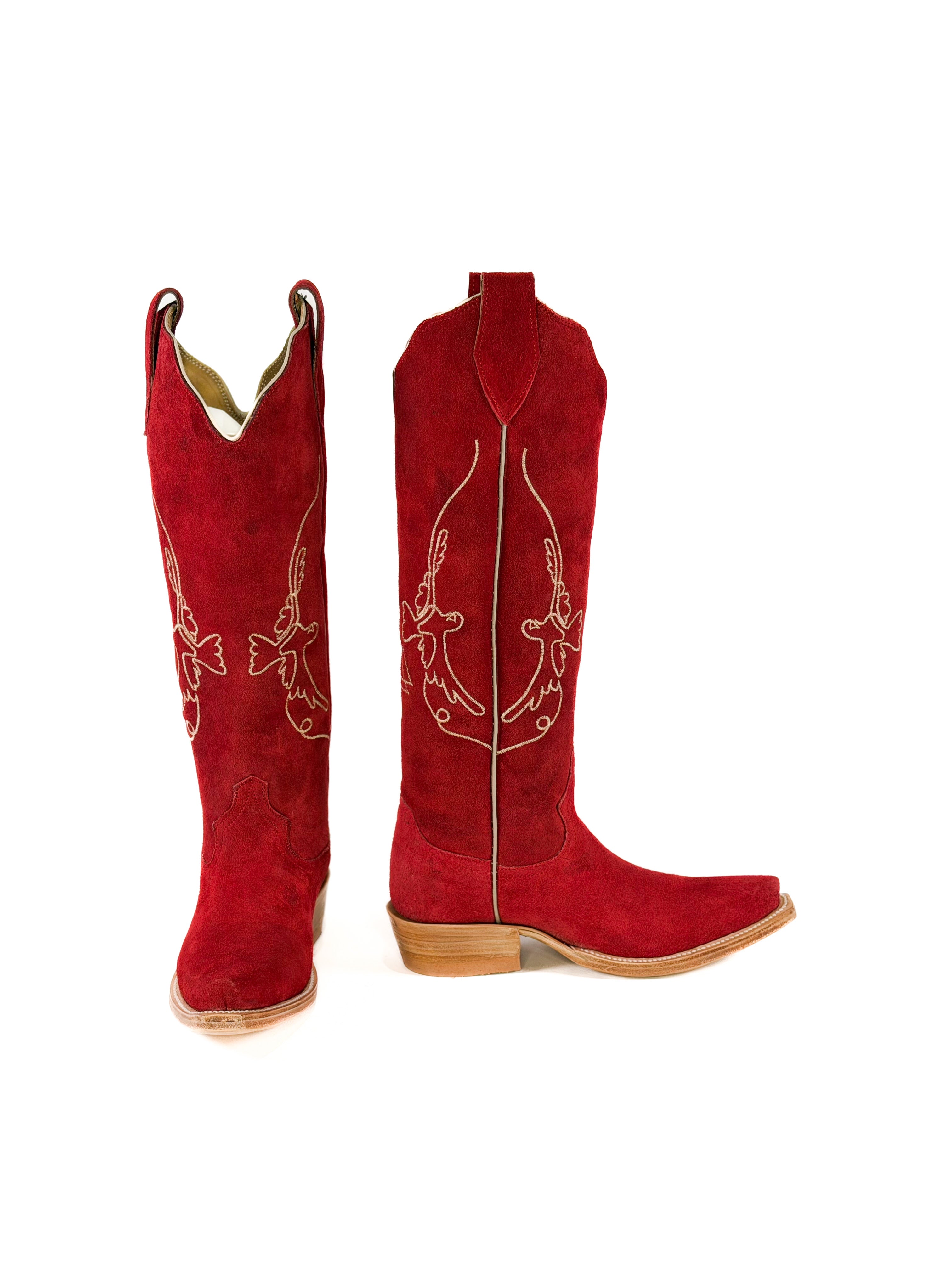 pair of red suede cowgirl boots with gold bird detailing