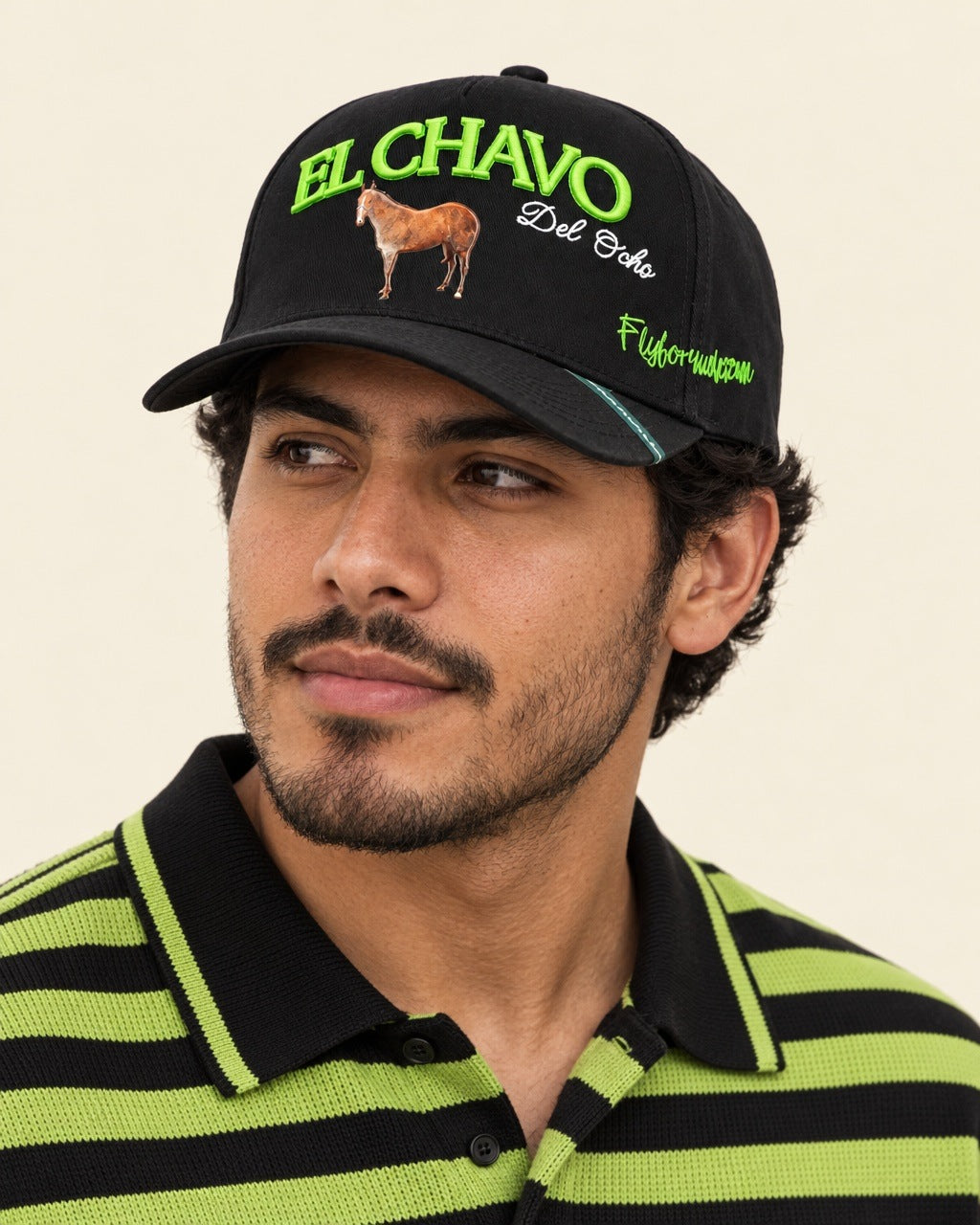 Chavo del Ocho Cap — worn with a lime and black striped knit polo