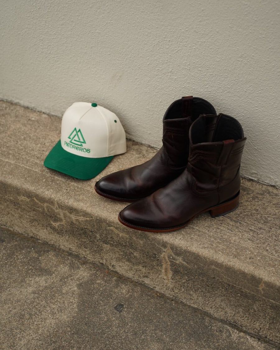 Inez's pick: Piedreros cap and roper boots on the curb