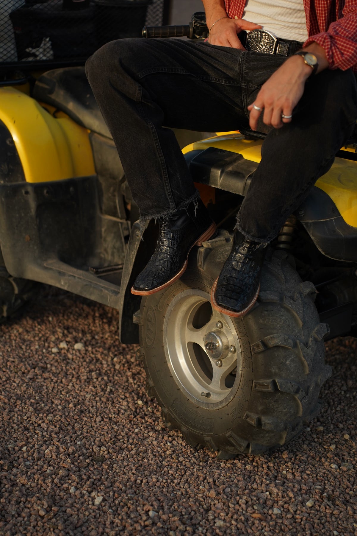 The Pecos boots on an ATV tire at the ranch