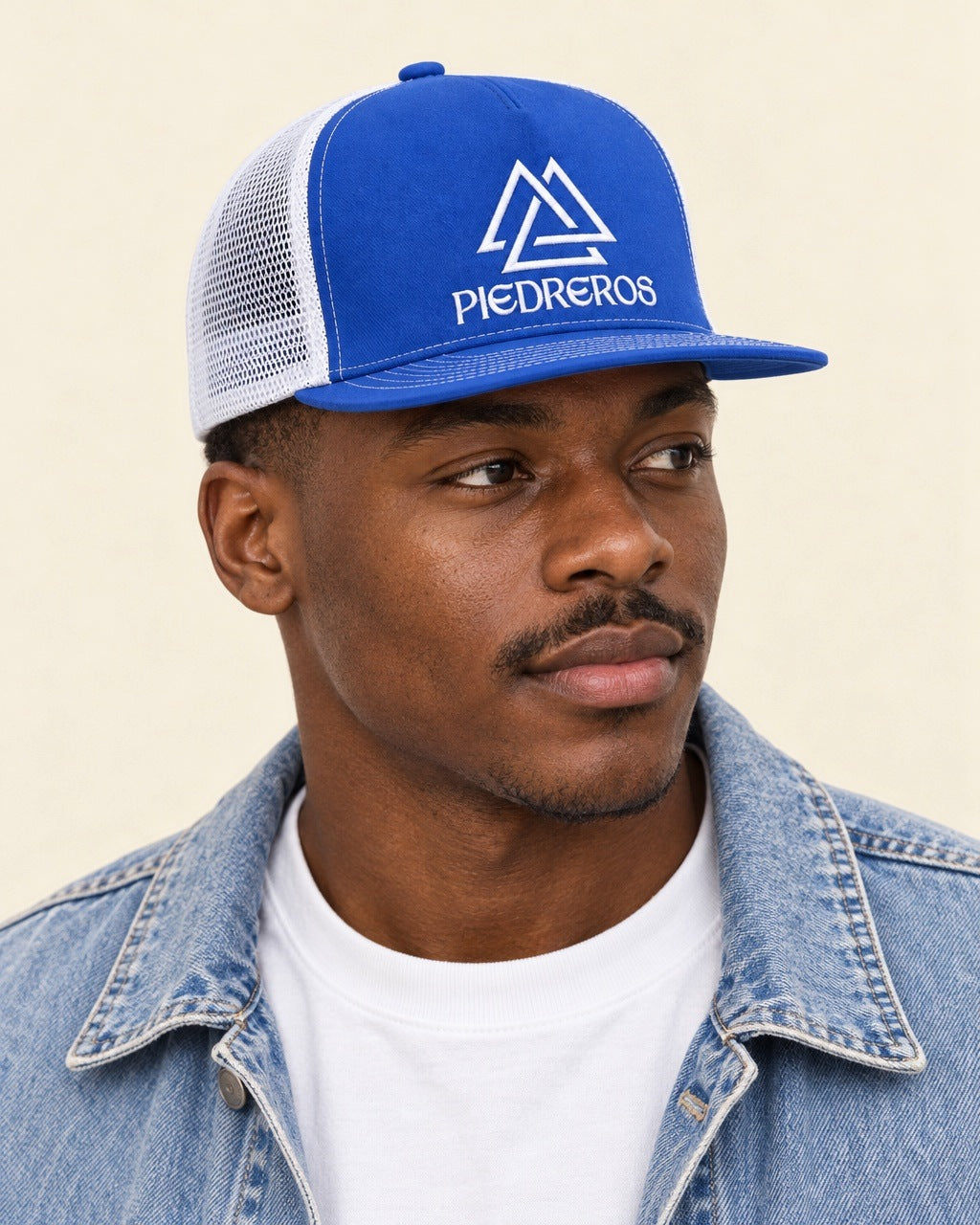 Piedreros Flat Snapback King — worn with a denim jacket and white tee