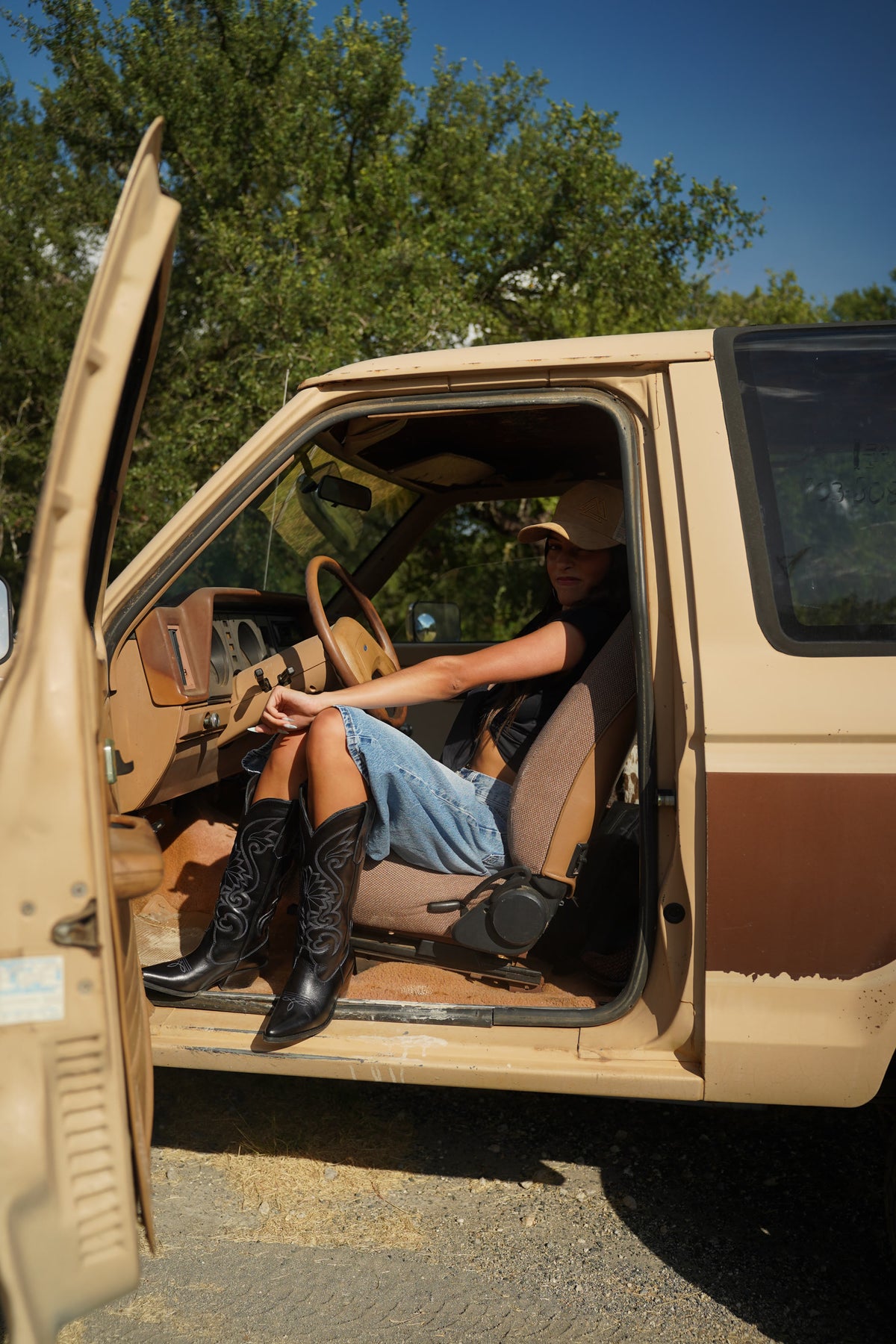 Woman sitting in a truck wearing The Sunburst black boots