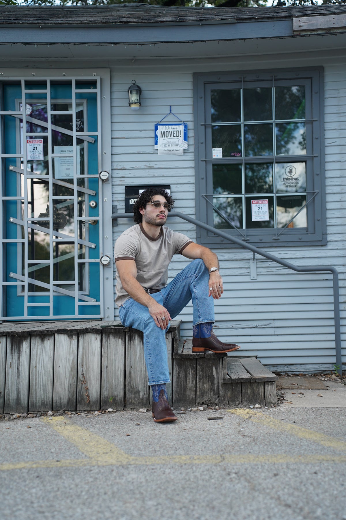 Dave sitting on porch steps wearing The Wharton boots